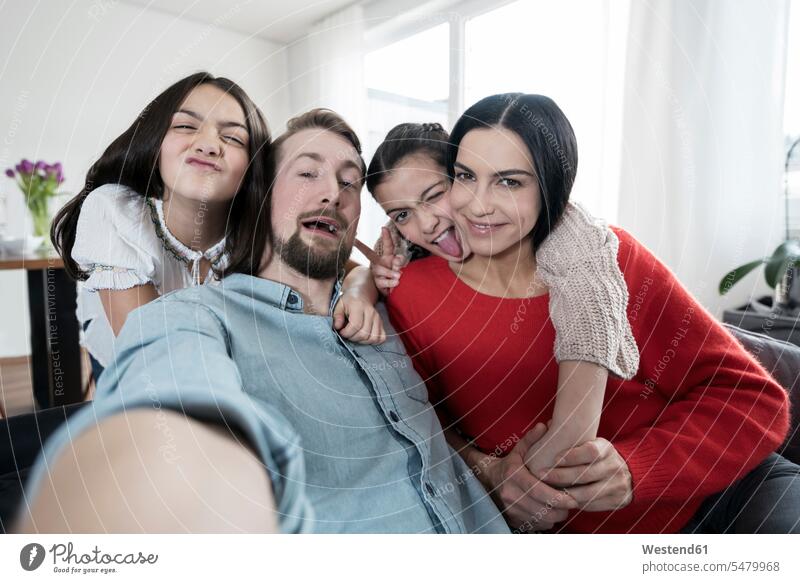 Parents and twin daughters fooling around taking a selfie portrait portraits family families Selfie Selfies people persons human being humans human beings child