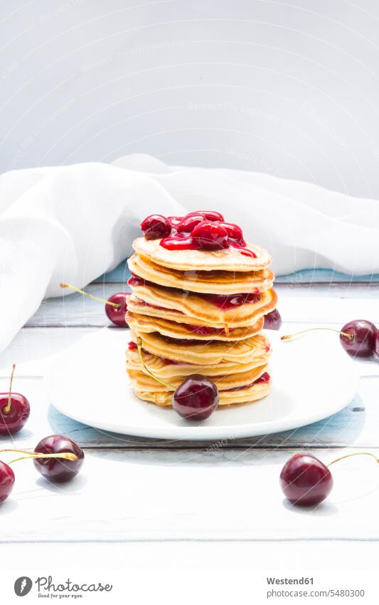 Stack of American pancakes with cherries and cherry groats food and drink Nutrition Alimentation Food and Drinks American cuisine stack stacked stacks prepared