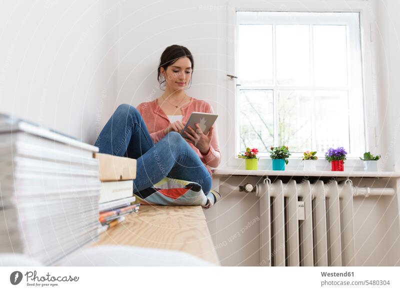 Young woman using digital tablet at the window digitizer Tablet Computer Tablet PC Tablet Computers iPad Digital Tablet digital tablets females women computer