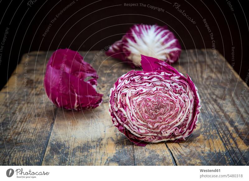 Sliced Radicchio Rosso di Chioggia on wood wooden close-up close up closeups close ups close-ups sliced Radicchio Salad Leaf Leaves head of lettuce half halves