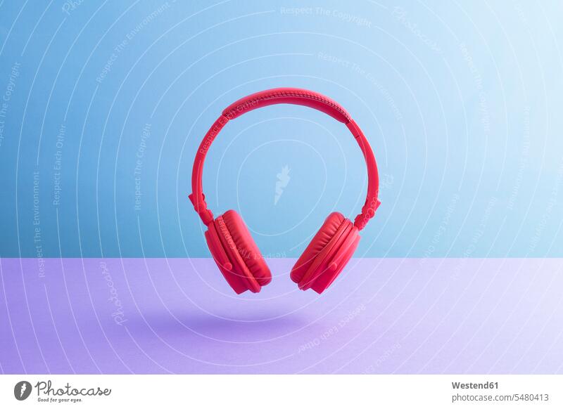 Red wireless headphones plain background cut out cutout single object 1 red copy space Bright Colour vibrant color vibrant colour Bright Color Bright Colours