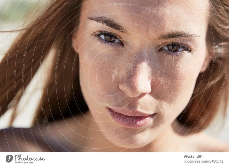 Close-up portrait of attractive young woman outdoors face faces serious earnest Seriousness austere females women portraits head heads people persons