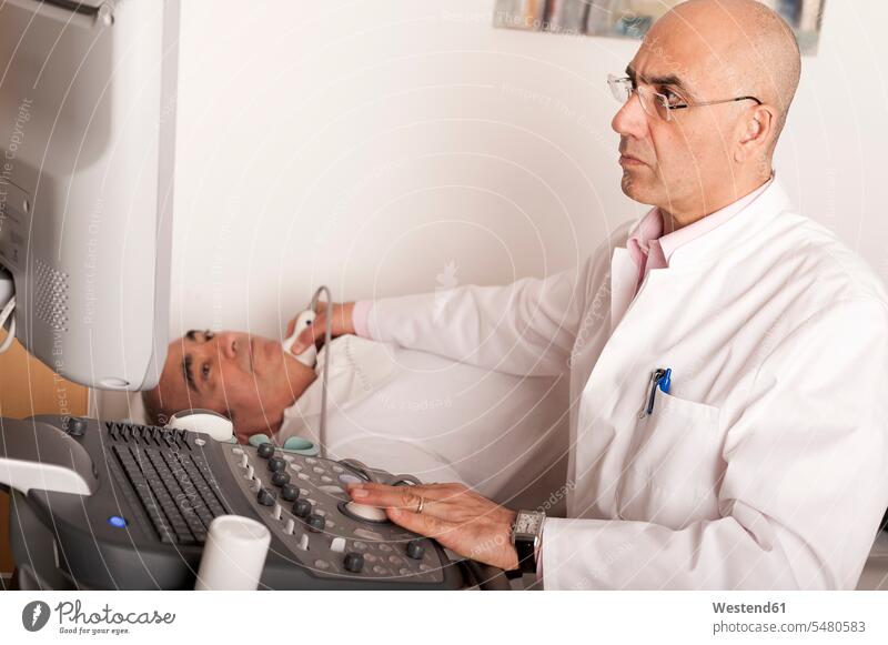 Radiologist examining carotid with ultraschall doctor physicians doctors examination examine examinations sonogram Ultrasonography preventative health care