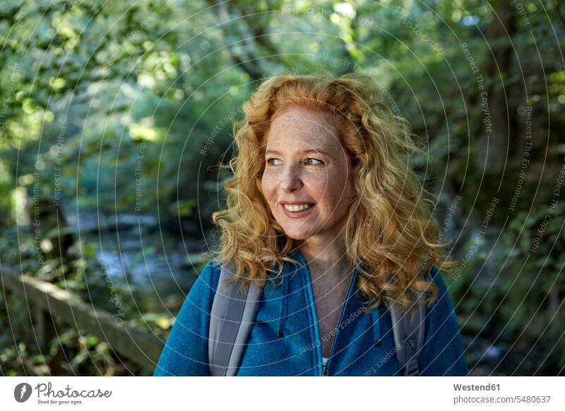 Woman hiking in forest, portrait portraits woods forests hike blond blond hair blonde hair smiling smile female hiker female wanderers woman females women