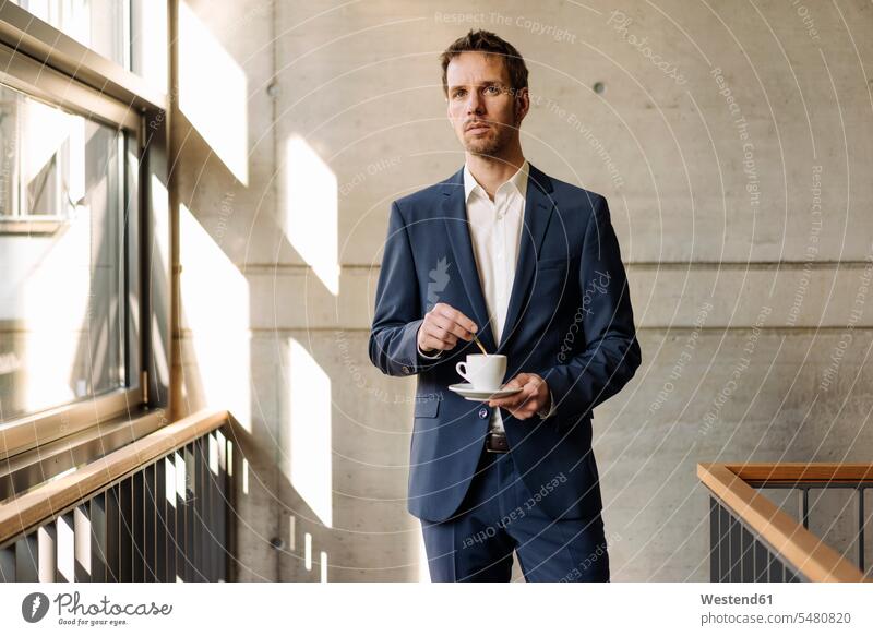 Businessman with cup of coffee in staircase Coffee Business man Businessmen Business men Drink beverages Drinks Beverage food and drink Nutrition Alimentation