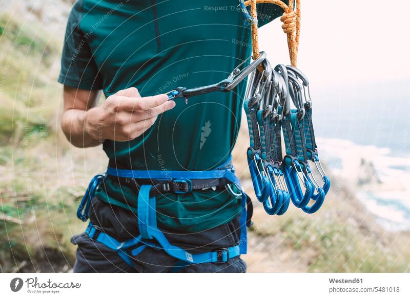 Young man preparing climbing equipment - a Royalty Free Stock Photo from  Photocase