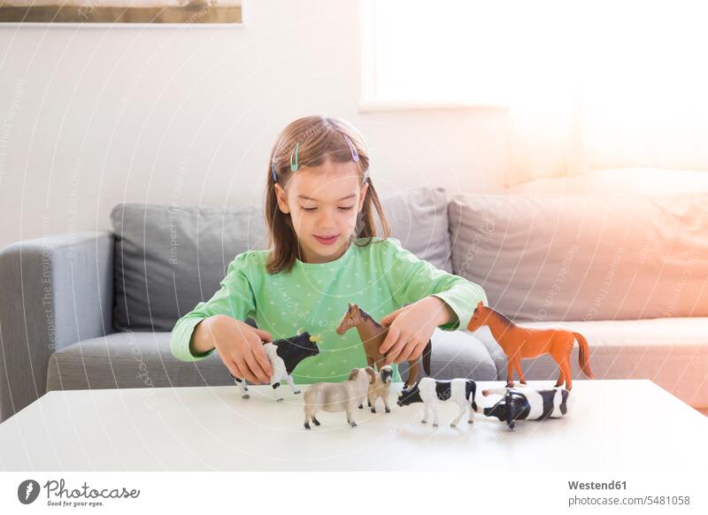Little girl playing with animal figurines at home females girls child children kid kids people persons human being humans human beings portrait portraits