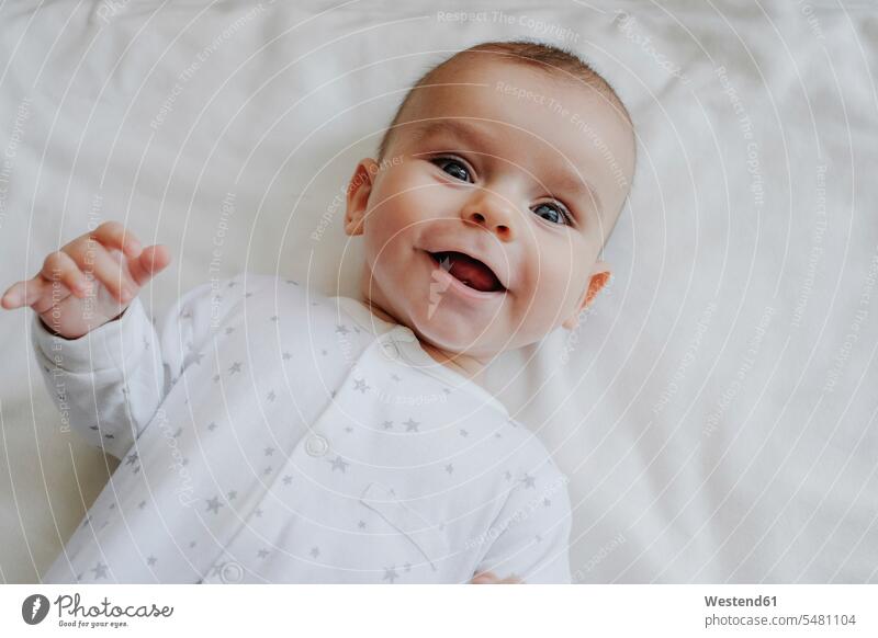 Portrait of laughing baby boy portrait portraits baby boys male babies infants people persons human being humans human beings Laughter bed beds lying