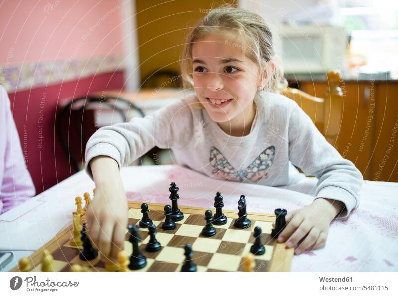 Little girl playing chess females girls board game board-games boardgame board games parlor game parlour games parlor games child children kid kids people