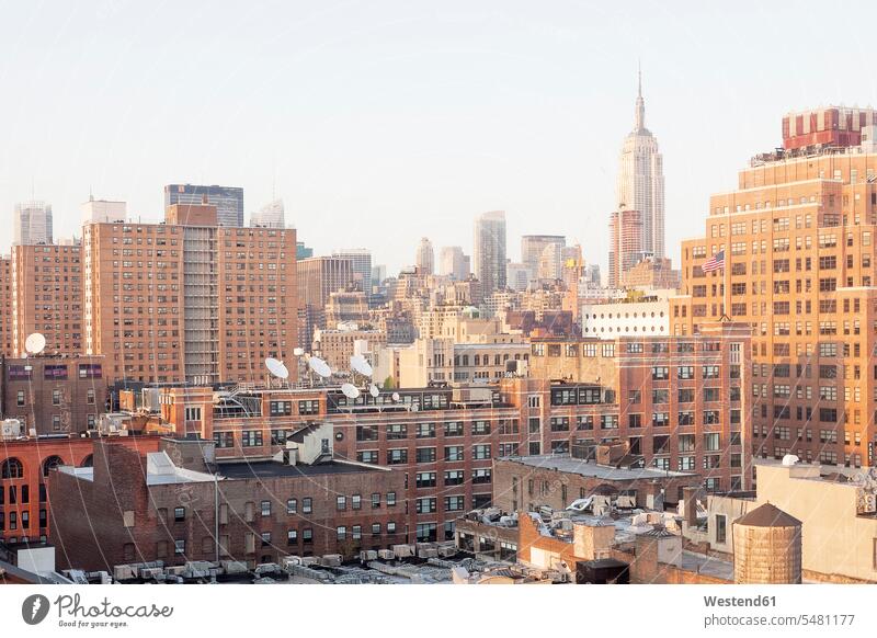 USA, New York City, Meatpacking District with Empire State Building in the background landmark Emblem urban scene brick house brick houses satellite dish