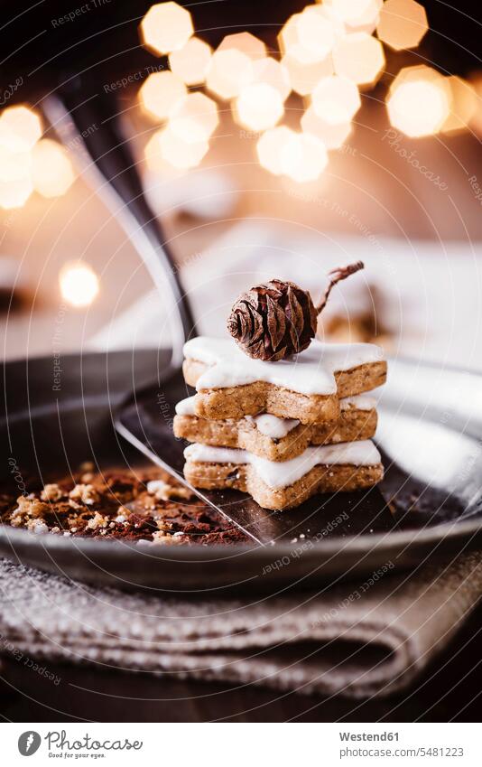 Stack of three cinnamon stars on plate Christmas Cookie Christmas Cookies Christmas Biscuits icing sugar icing frosting still life still-lifes still lifes