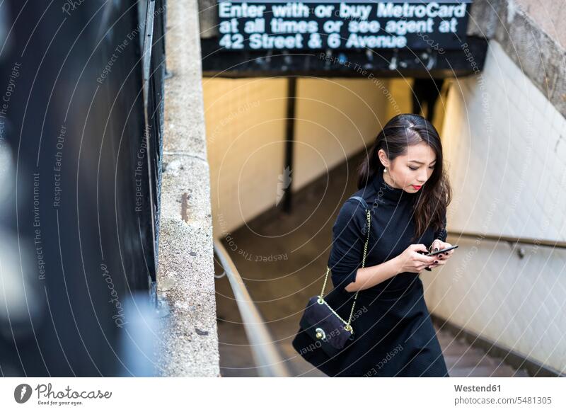 Young Woman Holding Phone Walking On Street High-Res Stock Photo - Getty  Images