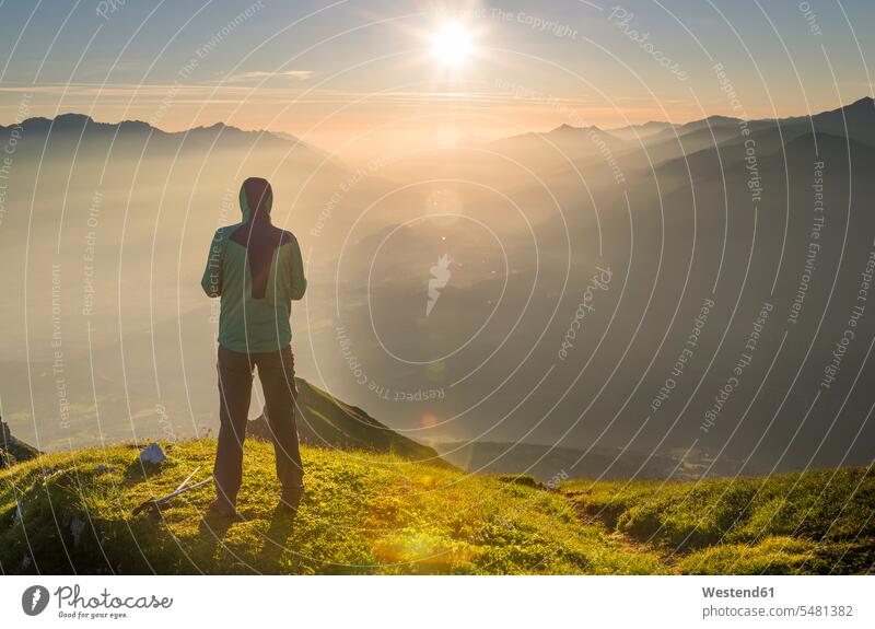 Austria, Tyrol, hiker looking at distance at sunrise journey travelling Journeys voyage standing observation point viewpoint lookout point wanderers hikers