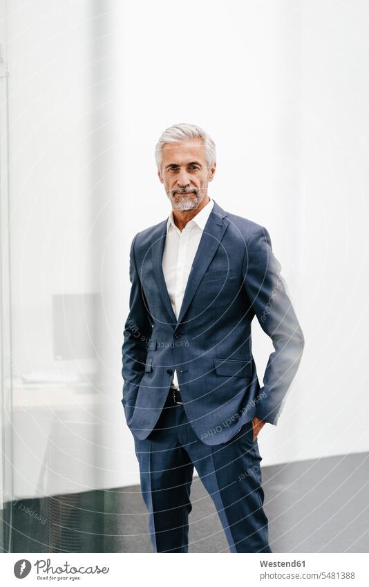 Portrait of confident mature businessman in office offices office room office rooms Businessman Business man Businessmen Business men portrait portraits