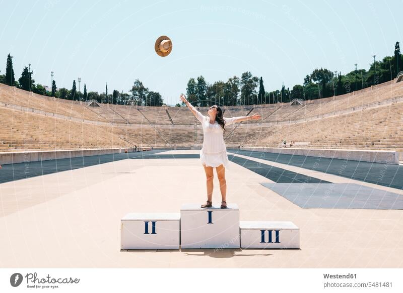 Greece, Athens, woman on the podium celebrating in the Panathenaic Stadium rostrum female tourist stadium stadiums sport stadiums happiness happy females women