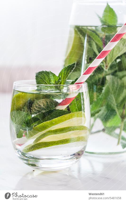 Glass and carafe of detox water with mint and limes food and drink Nutrition Alimentation Food and Drinks mint leaf mint leaves ready to eat ready-to-eat