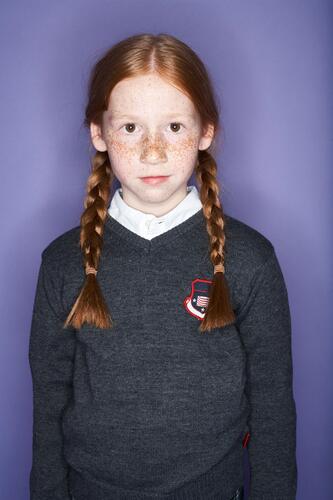 Portrait of redheaded girl with freckles portrait portraits females girls school uniform school uniforms child children kid kids people persons human being