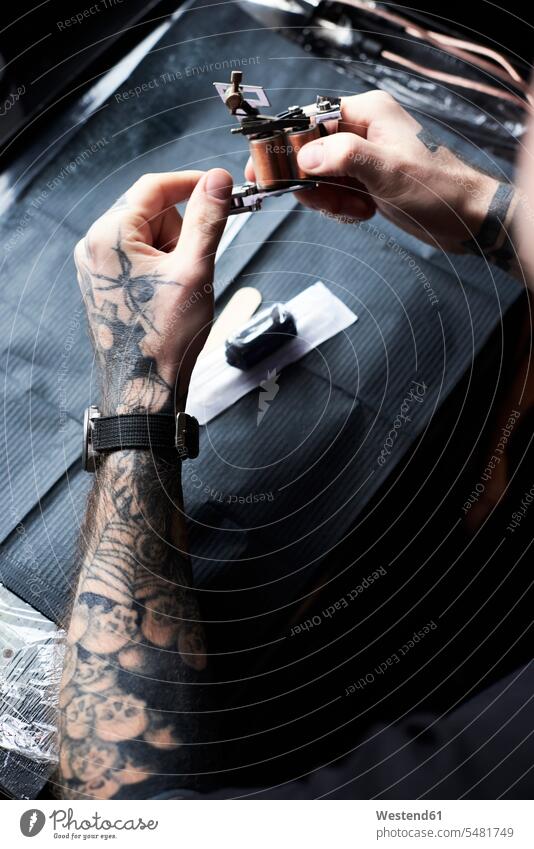 Tattoo artist at work in studio man men males tattooist tattooer studios working At Work tattoos Adults grown-ups grownups adult people persons human being