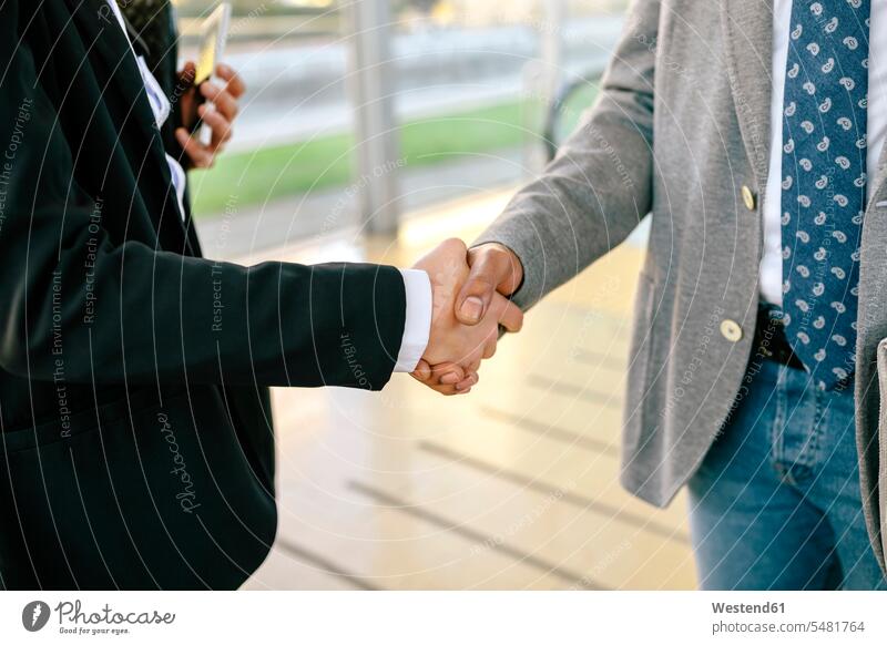 Young businessman and woman shaking hands, close up Farewell Farewells Good-Bye Goodbye colleagues partnership associates partnerships human hand human hands