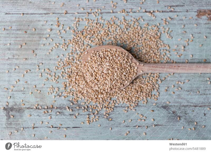 Wooden spoon and sesame seeds on wood Cooking Spoon Cooking Spoons scattered wooden spoon wooden spoons overhead view from above top view Overhead Overhead Shot