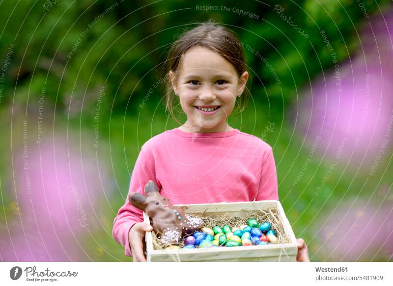 Portrait of happy little girl holding Easter nest portrait portraits females girls child children kid kids people persons human being humans human beings