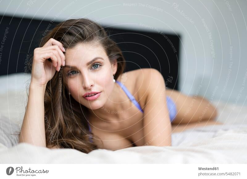 Woman in lingerie lying on bed beds laying down lie lying down woman females women Adults grown-ups grownups adult people persons human being humans