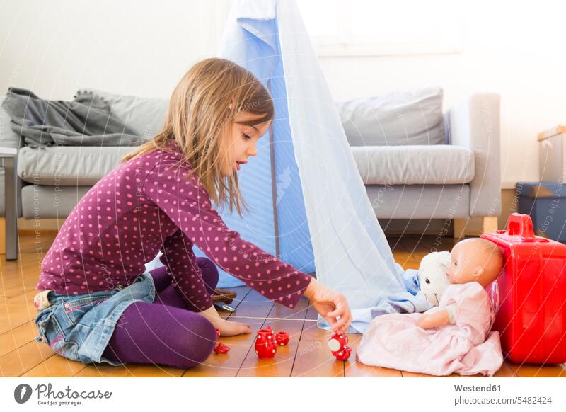 Little girl playing coffee party with her toys on the floor at home females girls Floor Floors child children kid kids people persons human being humans