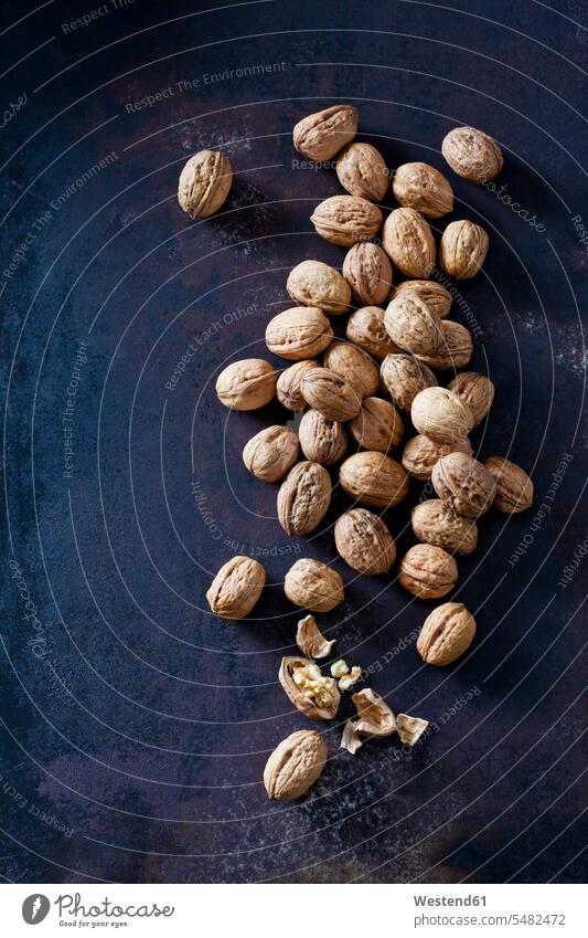 Whole and cracked walnuts on dark metal overhead view from above top view Overhead Overhead Shot View From Above large group of objects many objects Freshness
