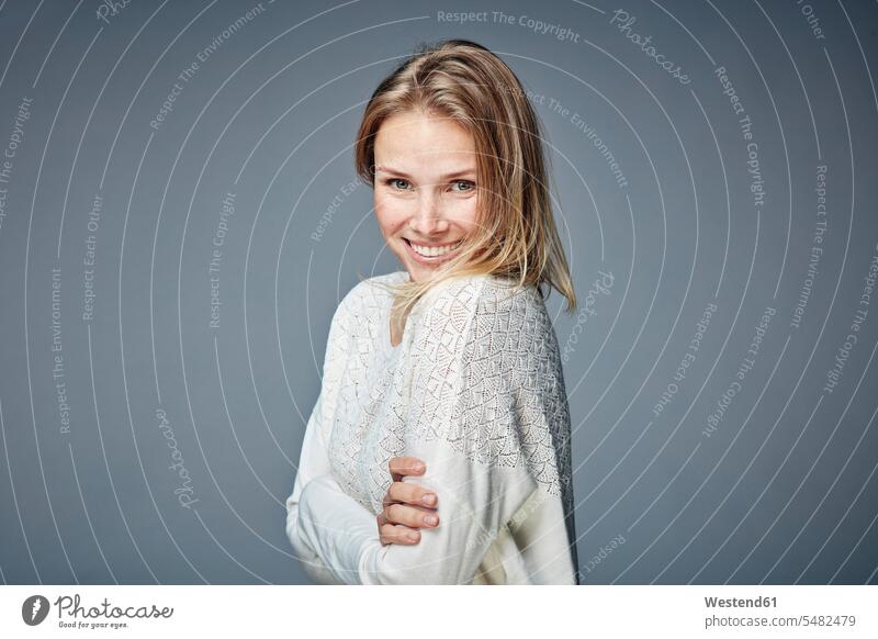 Portrait of smiling young woman standing wearing bra and pyjama pants - a  Royalty Free Stock Photo from Photocase