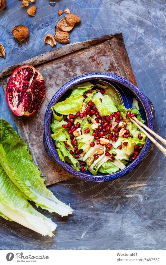 Bowl of Romaine lettuce with walnuts, pomegranate dressing and seed food and drink Nutrition Alimentation Food and Drinks Plate dish dishes Plates salad servers
