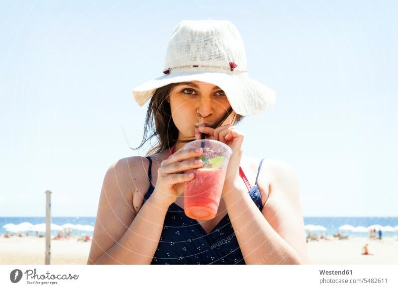 Young woman drinking cocktail on the beach Lemonade beaches young attractive beautiful pretty good-looking Attractiveness Handsome females women soft drink