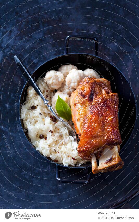 Knuckle of pork with bread dumplings and Sauerkraut in roasting tray Cooking Pot Pots Cooking Pots juniper berry juniper berries knuckle of pork Schweinshaxe