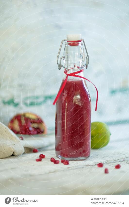 Glass bottle of pomegranate smoothie food and drink Nutrition Alimentation Food and Drinks Hoop lock red close-up close up closeups close ups close-ups