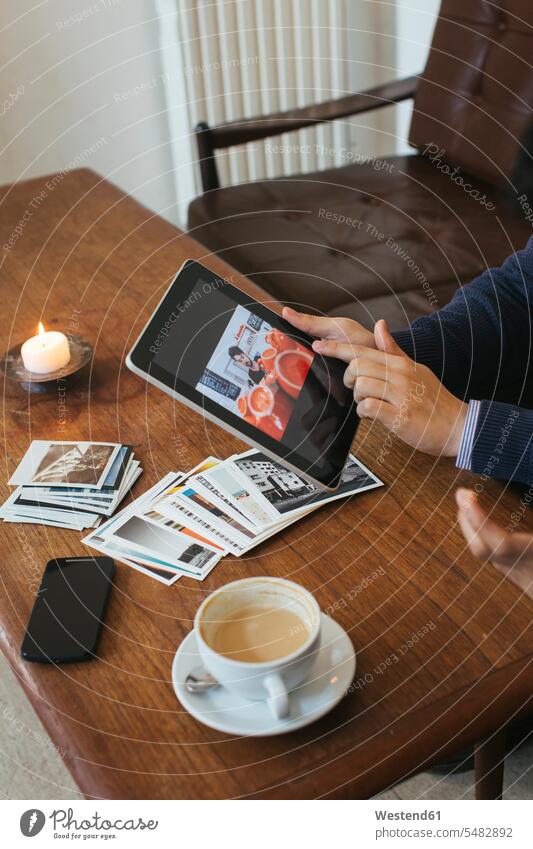 Man in a cafe showing picture on digital tablet caucasian caucasian ethnicity caucasian appearance european looking eyeing Coffee Germany motif motive indoors