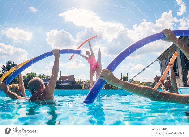 Group of seniors with trainer doing water gymnastics in pool group of people groups of people senior adults old swimming pool pools swimming pools aqua aerobics