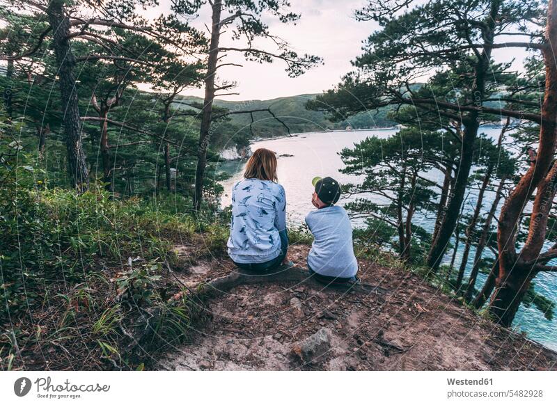 Russia, Far East, Khasanskiy, Japanese sea, mother and son sitting at Telyakovsky bay Seated ocean mommy mothers ma mummy mama sons manchild manchildren water