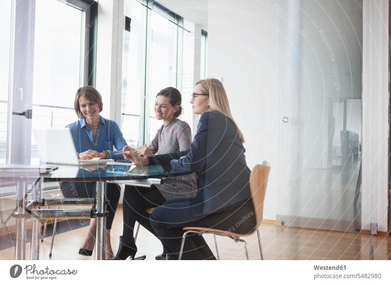 Three businesswomen looking at laptop caucasian caucasian ethnicity caucasian appearance european business world business life businesswoman business woman