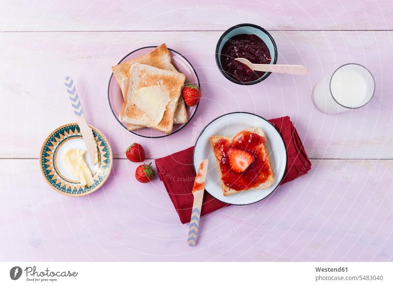 Toast and strawberry marmelade napkin napkins cloth napkin cloth napkins nobody spoon spoons overhead view from above top view Overhead Overhead Shot