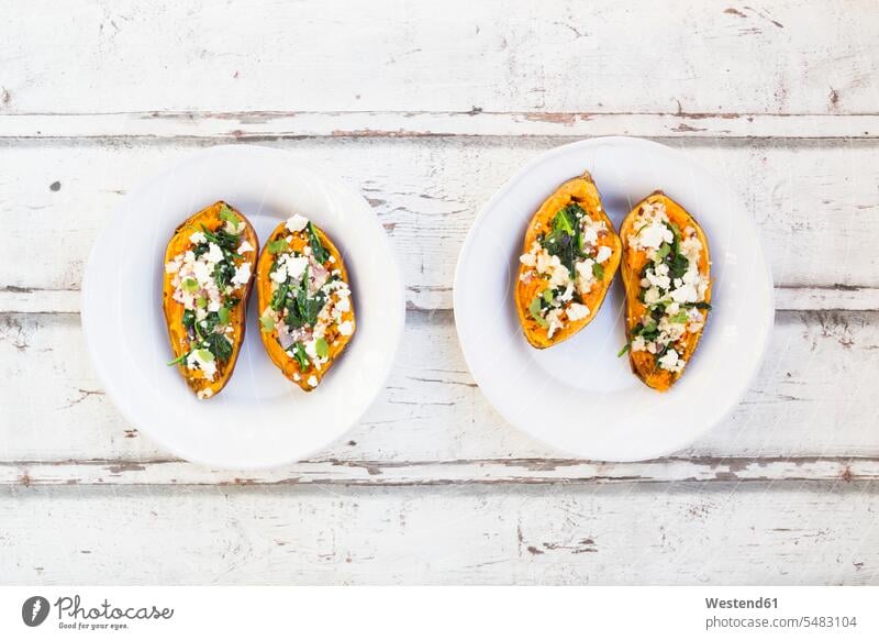 Filled sweet potato with spinach, red onion, couscous, feta and coriander Plate dish dishes Plates healthy eating nutrition prepared filled cilantro