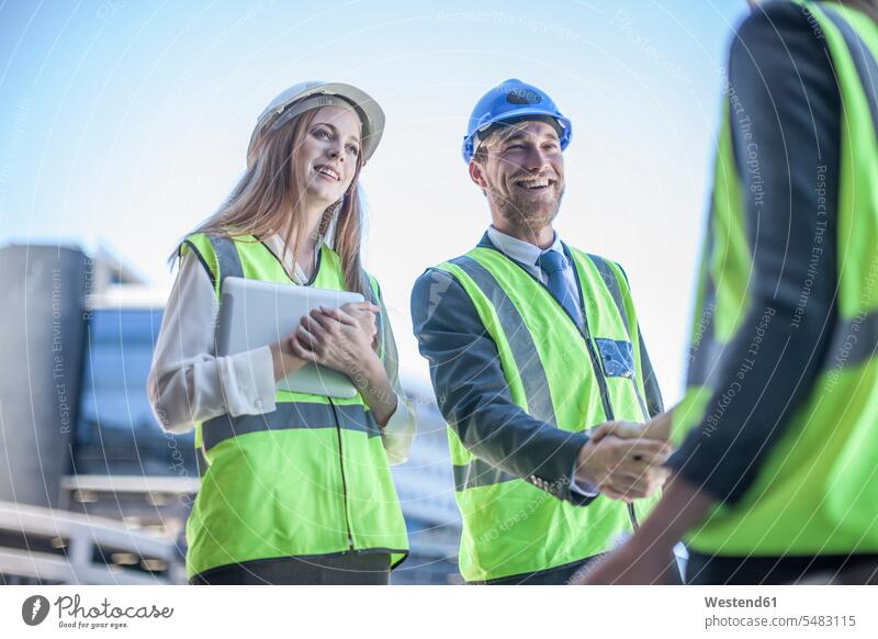 Architect and engineer at construction site discussing project Mobility mobile Business Meeting business conference meeting communication talking conversations