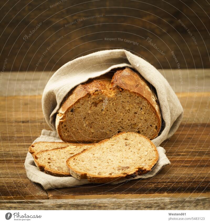 Sliced bread in linen cloth food and drink Nutrition Alimentation Food and Drinks rustic Slice of Bread Slices of Bread sliced wooden copy space loaf of bread