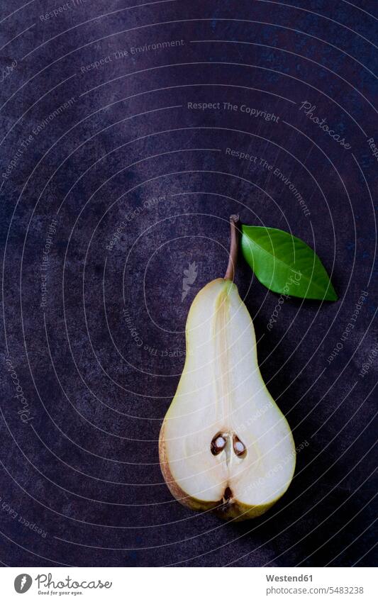 Sliced pear with leaf on dark ground nobody still life still-lifes still lifes Fruit Fruits copy space Leaf Leaves Light Abate Fetel stalk Stipes Plant Stem