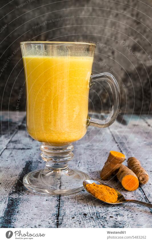 Glass of curcuma milk turmeric nobody homemade home made home-made Spoon Spoons healthy eating nutrition yellow Curcuma Turmeric Curcuma longa powder powders