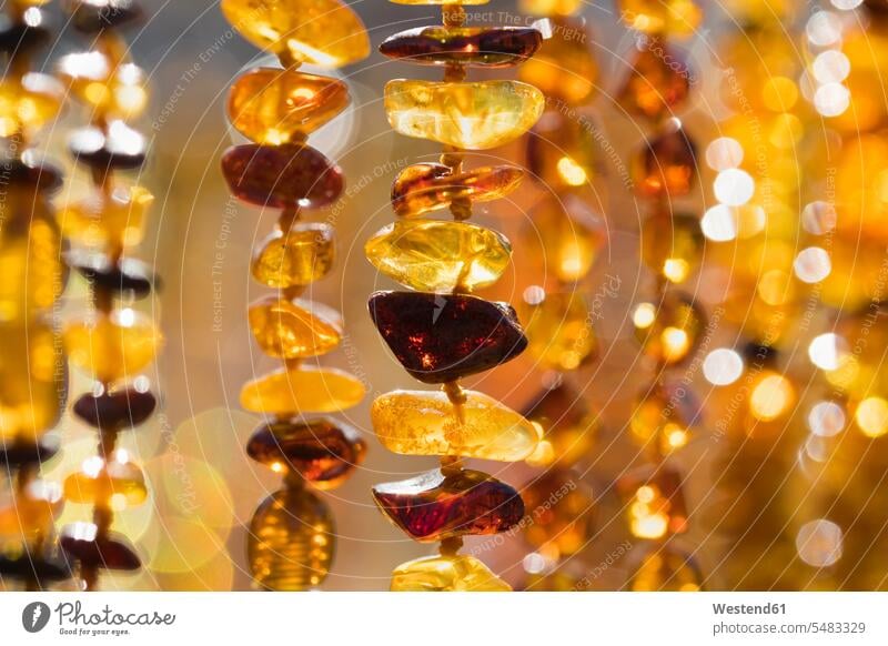 Amber necklaces shine shining shiny sparkling sparkle Glint Glisten Glinting Glistening Heringsdorf yellow focus on foreground Focus In The Foreground