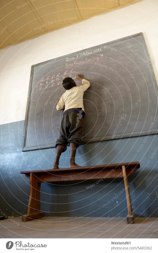 Madagascar, Fianarantsoa, Schoolboy writing on blackboard African descent coloured Knowledge pedagogics pupil schoolchildren pupils one person 1 one person only