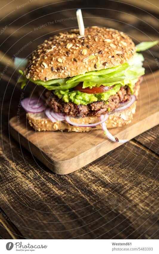 Vegetarian Burger with beetroot patty, avocado cream, salad and onions fast food fastfood lettuce Salad garnished healthy eating nutrition Chopping Board