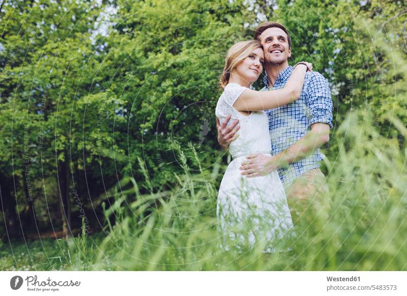 Portrait of happy couple in nature partnership three-quarter length three quarter length confidence confident embracing embrace Embracement hug hugging Solitude