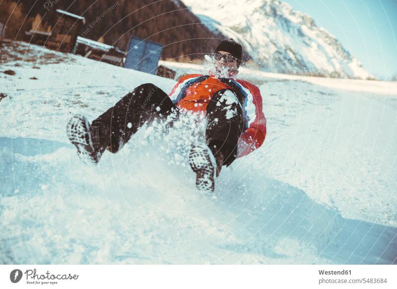 Italy, Val Venosta, Slingia, man sleighing down a snowy hill caucasian caucasian ethnicity caucasian appearance european Enjoyment Amusement pleasure enjoy