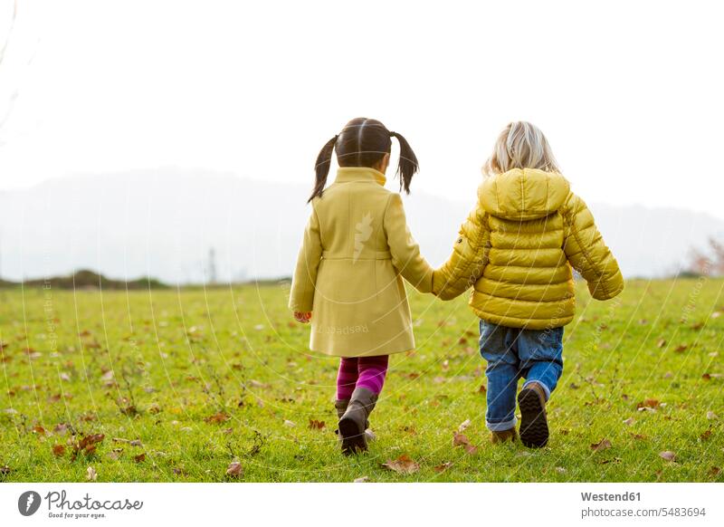 Vietnamese girl and caucasian boy playing outdoor in fall season caucasian ethnicity caucasian appearance european two people 2 2 persons 2 people two persons