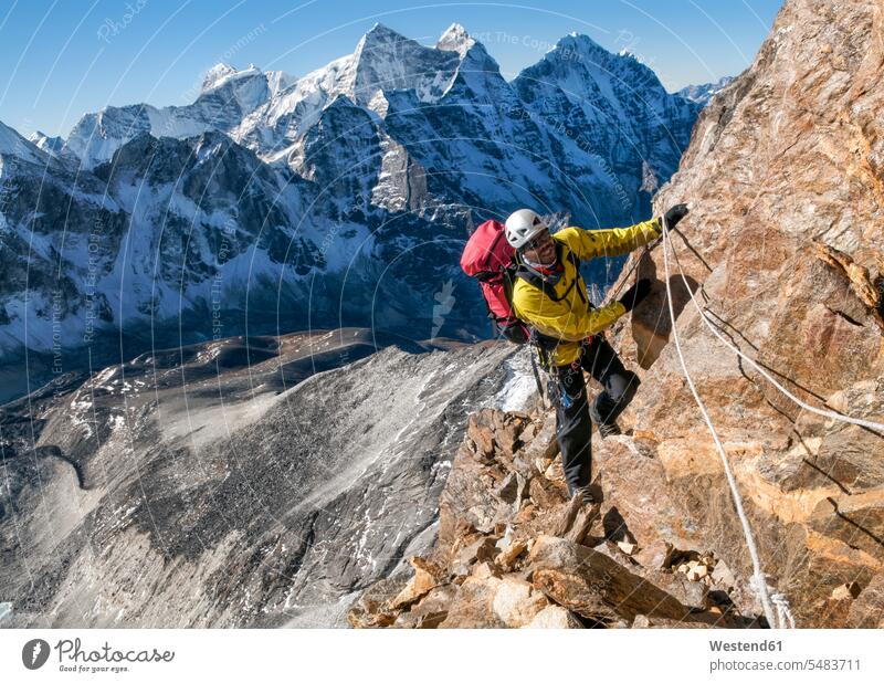 Nepal, Himalaya, Solo Khumbu, Ama Dablam South West Ridge, mountaineer climbing up rocks man men males climber alpinists climbers Mountain Climber mountaineers